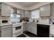 Stylish kitchen featuring gray cabinets, black appliances, and tile backsplash at 117 Saint Albans Ct, Henderson, NV 89015