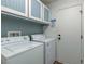 Well-lit laundry room with overhead cabinets and modern appliances at 117 Saint Albans Ct, Henderson, NV 89015
