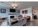 Inviting living room featuring a cozy fireplace and ceiling fan at 117 Saint Albans Ct, Henderson, NV 89015