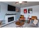 Relaxing living room featuring a fireplace, ceiling fan, and comfortable seating at 117 Saint Albans Ct, Henderson, NV 89015