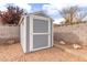 Storage shed in backyard with a block wall and gravel for functionality and privacy at 117 Saint Albans Ct, Henderson, NV 89015