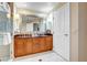 Bathroom featuring a vanity with dual sinks and large mirror at 135 E Harmon Ave # 3704, Las Vegas, NV 89109