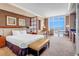 Comfortable bedroom suite featuring a king bed, sitting area, work space and large window at 135 E Harmon Ave # 3704, Las Vegas, NV 89109