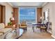 Bright living room showcasing comfortable seating, a table, and city views from the large window at 135 E Harmon Ave # 3704, Las Vegas, NV 89109