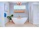Elegant bathroom featuring a freestanding tub, modern fixtures, and natural light at 1601 Fairgate Ct, Las Vegas, NV 89117