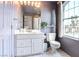 Well-lit bathroom features a vanity with sink, toilet, and window with a view of the exterior at 1601 Fairgate Ct, Las Vegas, NV 89117