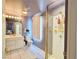 Well-lit bathroom features vanity with sink, toilet, shower, and view of the bedroom through a mirror at 1601 Fairgate Ct, Las Vegas, NV 89117