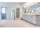 Bright, luxurious bathroom with double sinks, sleek mirrors, and soft lighting at 1601 Fairgate Ct, Las Vegas, NV 89117