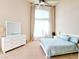 Bright bedroom features a high ceiling, large window with curtains, and light-colored furniture at 1601 Fairgate Ct, Las Vegas, NV 89117