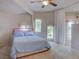 Spacious bedroom features two windows with curtains and a bed with unique lighting at 1601 Fairgate Ct, Las Vegas, NV 89117