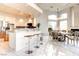 Open floor plan shows a kitchen with breakfast bar adjacent to dining room and fireplace at 1601 Fairgate Ct, Las Vegas, NV 89117