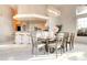 Bright dining room is adjacent to kitchen featuring breakfast bar and seating for eight at 1601 Fairgate Ct, Las Vegas, NV 89117