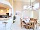 Sunlit dining room showcases views from large windows and shares a breakfast bar at 1601 Fairgate Ct, Las Vegas, NV 89117