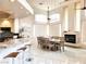 Open dining room has high ceilings, modern light fixture, fireplace and adjoins kitchen at 1601 Fairgate Ct, Las Vegas, NV 89117