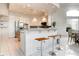 The kitchen features granite countertops, an adjacent breakfast bar and stainless appliances at 1601 Fairgate Ct, Las Vegas, NV 89117