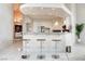 The kitchen includes bar seating, pendant lighting and stainless steel appliances at 1601 Fairgate Ct, Las Vegas, NV 89117
