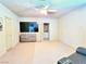 Spacious living room features a large television, neutral walls, and an open doorway to the bathroom at 1601 Fairgate Ct, Las Vegas, NV 89117