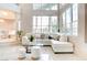 Bright living room with high ceilings, a wall of windows, tiled floors and a cozy seating area at 1601 Fairgate Ct, Las Vegas, NV 89117