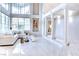 Bright living room with high ceilings, a wall of windows, tiled floors and a cozy seating area at 1601 Fairgate Ct, Las Vegas, NV 89117