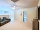 Comfortable living room with leather chairs, neutral walls, and view of a bathroom through open doorway at 1601 Fairgate Ct, Las Vegas, NV 89117