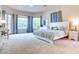 Large, sun-filled main bedroom with plush carpet and blue accents at 1601 Fairgate Ct, Las Vegas, NV 89117