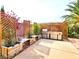 Outdoor kitchen with stainless steel grill, lattice wall, wooden planter boxes and a concrete patio at 1601 Fairgate Ct, Las Vegas, NV 89117