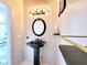 Elegant powder room featuring a pedestal sink, modern lighting, and neutral decor at 1601 Fairgate Ct, Las Vegas, NV 89117
