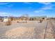 Spacious gravel backyard with shed and house, offering plenty of room for outdoor activities or landscaping at 1720 S Blagg Rd, Pahrump, NV 89048