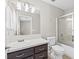 Clean bathroom with vanity, dark wood cabinets, and shower-tub combo with a glass enclosure at 1720 S Blagg Rd, Pahrump, NV 89048
