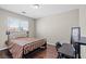 Bedroom with hardwood flooring, neutral paint, and a bed frame facing a window at 1720 S Blagg Rd, Pahrump, NV 89048