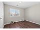 Guest bedroom with hardwood flooring, neutral paint, and lots of natural light from a large window at 1720 S Blagg Rd, Pahrump, NV 89048
