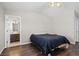 Neutral bedroom with a low bed frame and ensuite bathroom with dark wood cabinets at 1720 S Blagg Rd, Pahrump, NV 89048