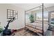 Bedroom featuring an exercise bike, a large mirror, a window and modern decor at 1720 S Blagg Rd, Pahrump, NV 89048