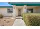 Charming front entrance with a decorative door, manicured shrubbery, and stylish outdoor sconces at 1720 S Blagg Rd, Pahrump, NV 89048
