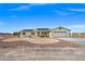 Inviting single-story home with desert landscaping, a two-car garage, and solar panels on a bright day at 1720 S Blagg Rd, Pahrump, NV 89048