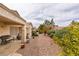 Well-maintained backyard with gravel landscaping, mature shrubbery, and covered patio at 2136 Eagle Sticks Dr. Dr, Henderson, NV 89012