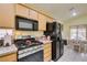 Efficient kitchen with laminate counters, a black refrigerator, and a view into the breakfast nook at 2136 Eagle Sticks Dr. Dr, Henderson, NV 89012