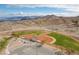 Aerial view of baseball fields, showing well-maintained green grass and red clay, set against a scenic mountain backdrop at 217 Big Horn Dr # 3, Boulder City, NV 89005