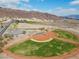 Community baseball fields, set against mountains, offer a recreational space with well-maintained grass and clay diamonds at 217 Big Horn Dr # 3, Boulder City, NV 89005