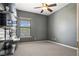 This bedroom features neutral carpet, a window, and a ceiling fan at 217 Big Horn Dr # 3, Boulder City, NV 89005