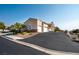A side-angled exterior shot of a tan home with a driveway and well-kept landscaping at 217 Big Horn Dr # 3, Boulder City, NV 89005