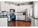 Bright kitchen featuring white cabinets, stainless steel appliances, and hardwood floors at 217 Big Horn Dr # 3, Boulder City, NV 89005