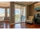 Cozy living room area with a fireplace, hardwood floors, and sliding door to a balcony at 217 Big Horn Dr # 3, Boulder City, NV 89005