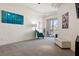 Spacious living room featuring plush carpeting, tray ceilings, and a sliding door to a balcony at 217 Big Horn Dr # 3, Boulder City, NV 89005