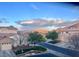 A neighborhood street with tidy homes, mature trees, and views of distant mountains at 217 Big Horn Dr # 3, Boulder City, NV 89005