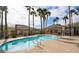 Relaxing community pool with lush palm trees and a comfortable seating area at 217 Big Horn Dr # 3, Boulder City, NV 89005