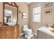 Elegant half-bathroom featuring a vessel sink, ornate vanity, and stylish decor at 223 Positive Point St, Henderson, NV 89012