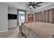 Relaxing bedroom with a large TV, a classic hutch, and a neutral color palette at 223 Positive Point St, Henderson, NV 89012
