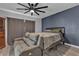 Comfortable bedroom with a large ceiling fan and a plush gray sofa at 223 Positive Point St, Henderson, NV 89012