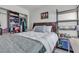 This bedroom features a bed, shelving, and art on the wall at 223 Positive Point St, Henderson, NV 89012